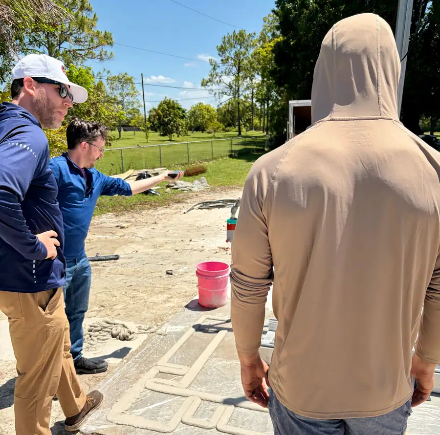 Team inspecting freshly printed concrete walls